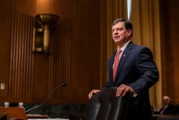 A photo of SSA chief Frank Bisignano standing in a Senate hearing room before his confirmation hearing began.