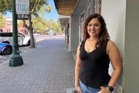 A photo of a woman standing outside.