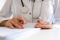 A photo of a doctor filling out a form.