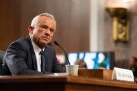 A photo of Robert F. Kennedy Jr. at his confirmation hearing in a Senate hearing room.