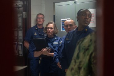 Four uniformed U.S. Public Health officers look out of frame.